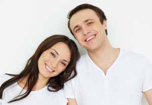 Portrait of amorous young couple looking at camera in isolation